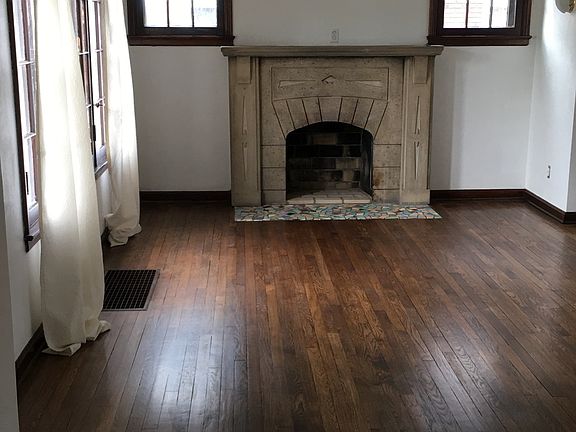 Hardwood floors throughout and antique stone decorative fireplace
