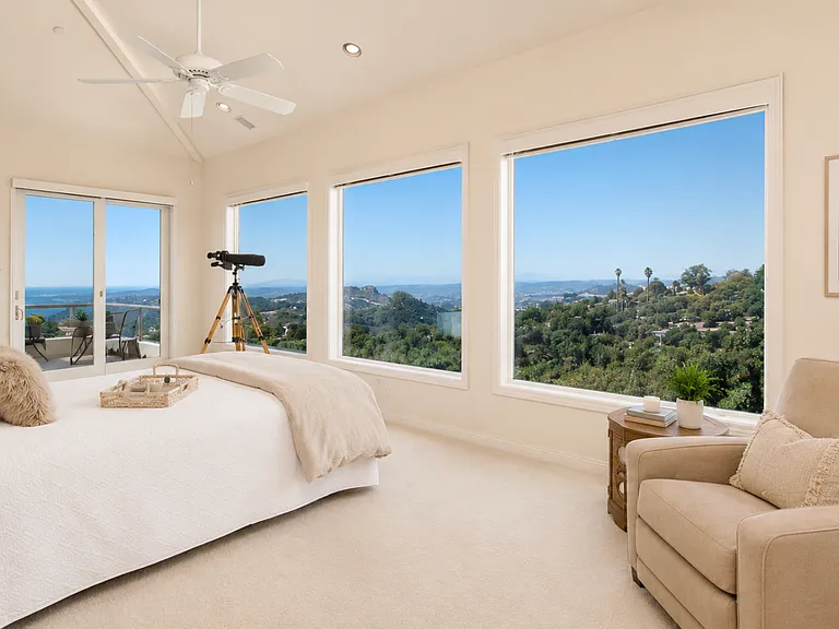 Relax in your primary suite and savor incredible panoramic views spanning from the mountains to the ocean, offering a vantage point that rivals the view from an airplane at over 1,000 feet in the air.