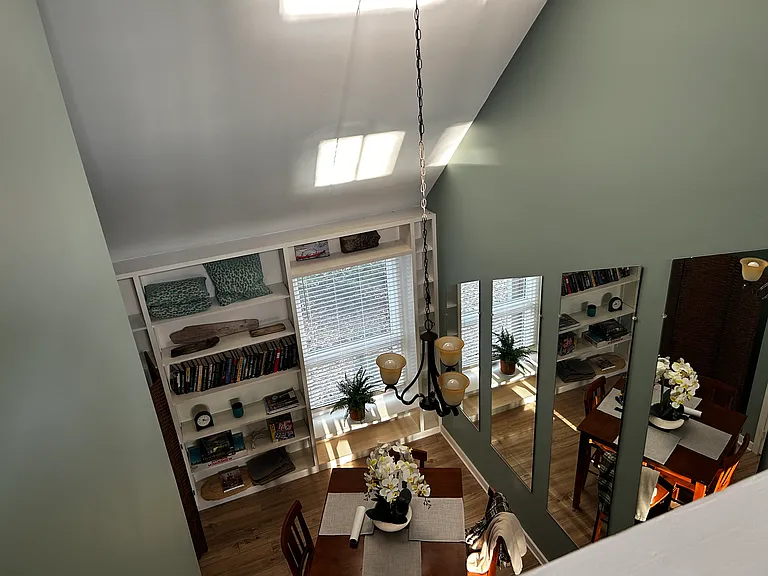 view from primary bed room to dining area below