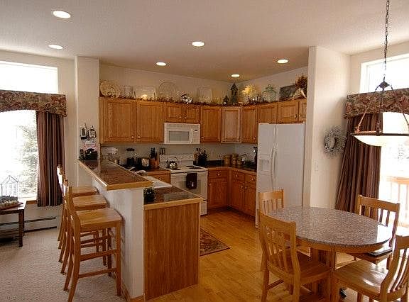 Open Kitchen with Granite Tile and Hardwood Floor