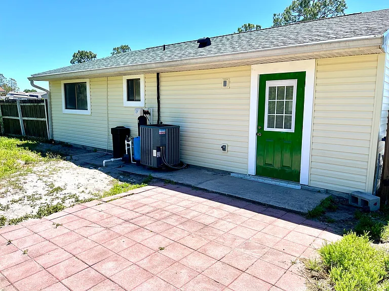 Back view. Patio. New well pump 2023. New water softening system 2022.