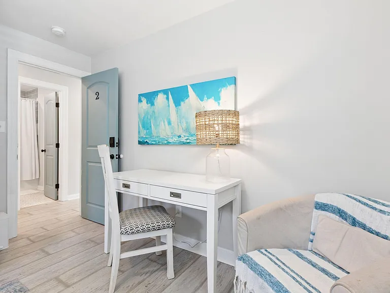 Private bedroom nook includes a dedicated desk and chair plus convenient access to the nearby bathroom.