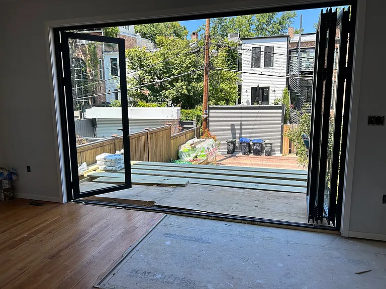 Old photo - installation of glass folding doors off dining room.