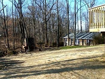 Spacious backyard with view of woods