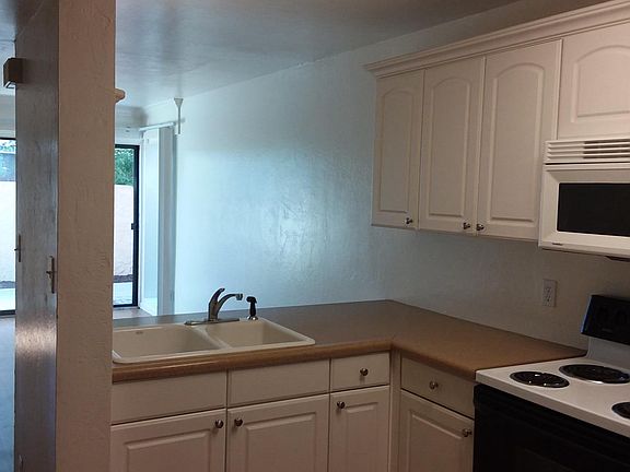 Ground level kitchen, living area, half bath and porch.