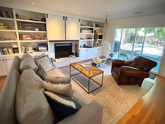 Sliding doors cover the 65" TV. A second TV lives in the family room...