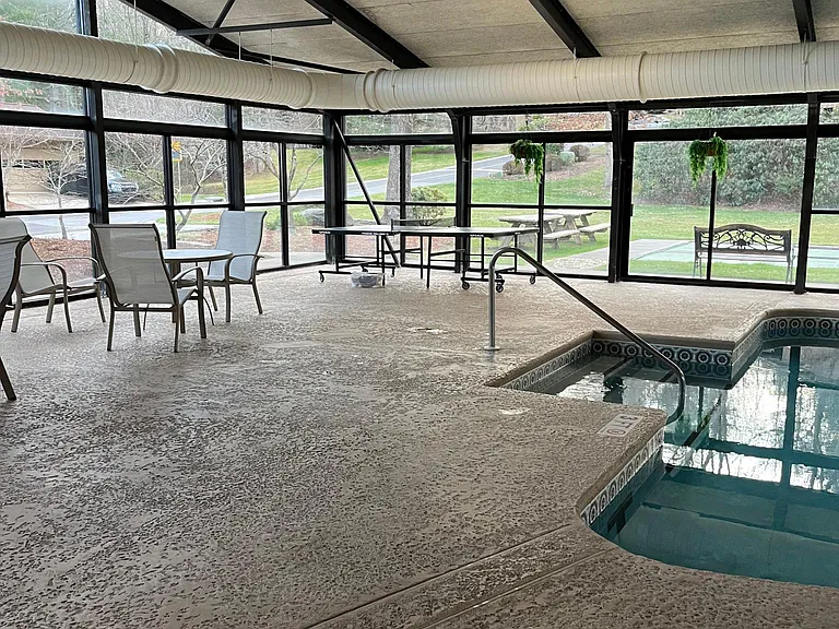 Ping pong. Safe handrail access to shallow end of pool. Shuffleboard court and picnic tables can be seen outside the pool windows.