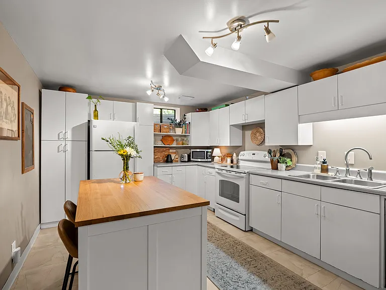 Basement apartment kitchen with electric range and dishwasher