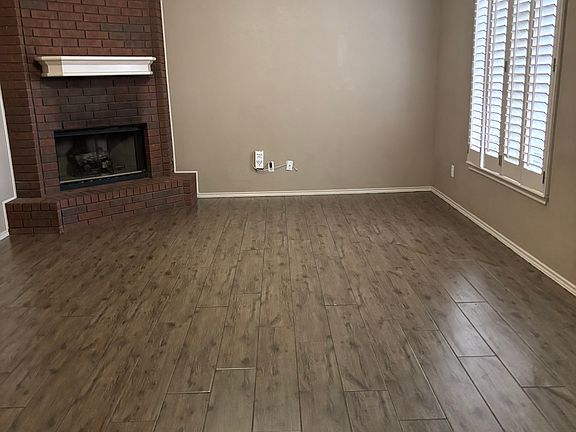 Living room with gas log fireplace and plantation shutters