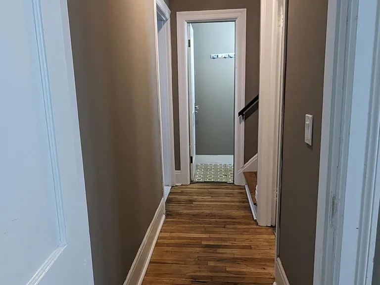 Hallway off kitchen to upstairs, downstairs, bathroom and main floor bedroom