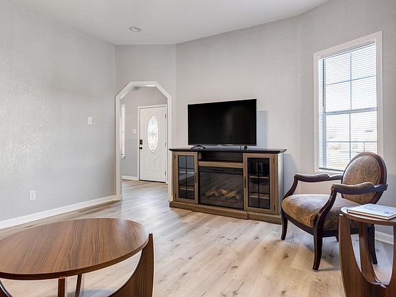Living room 
Furnished with sofa, end tables, comfortable sitting chair, Roku TV, and electric fireplace.