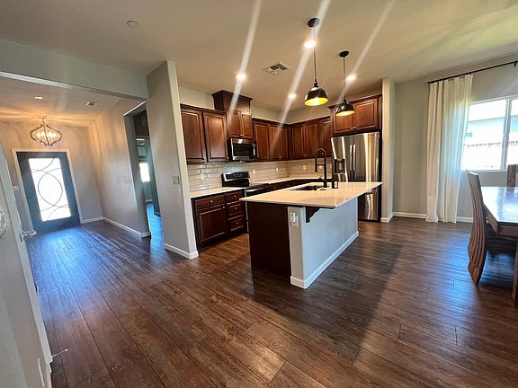 Induction cooktop, refrigerator, and a huge walk in pantry opposite of the kitchen