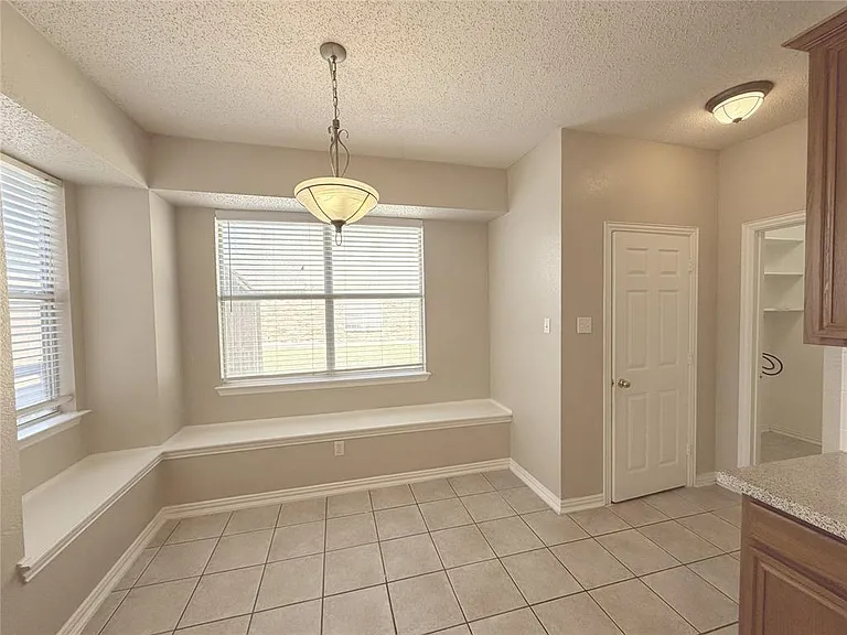 BREAKFAST AREA WITH WINDOW SEATING AND PANTRY.