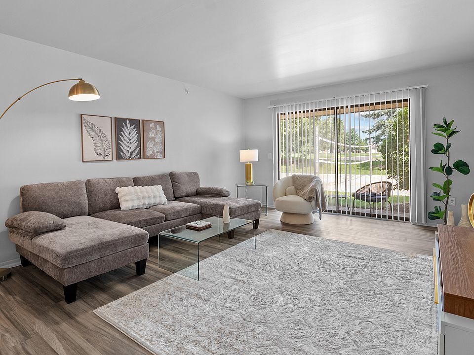 Living room with patio at Dover Hills Apartments in Kalamazoo
