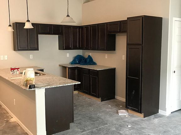 Kitchen, stained concrete floors