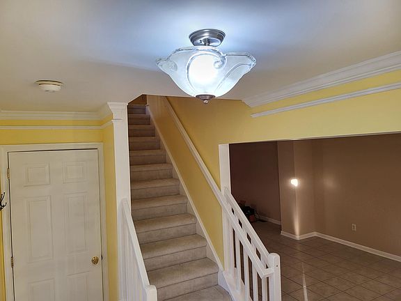 Entrance Foyer with access to the living room, family room, and upstairs