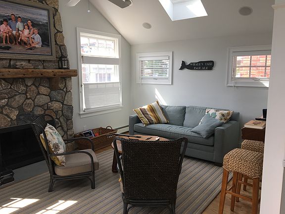 living room with stone fireplace