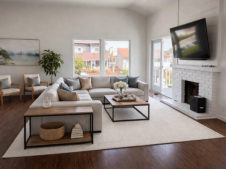 Living room with fireplace, vaulted ceilings, hardwood flooring and great natural light. *VIRTUALLY STAGED photo.