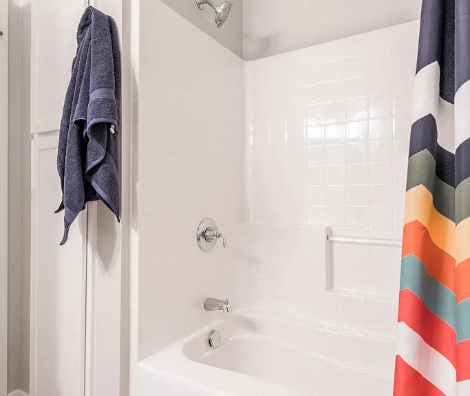 Our bathrooms feature a clean and modern design with a full-size tub and shower, perfect for relaxing and refreshing.