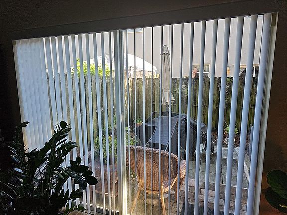 door with upgraded vertical blind to backyard
