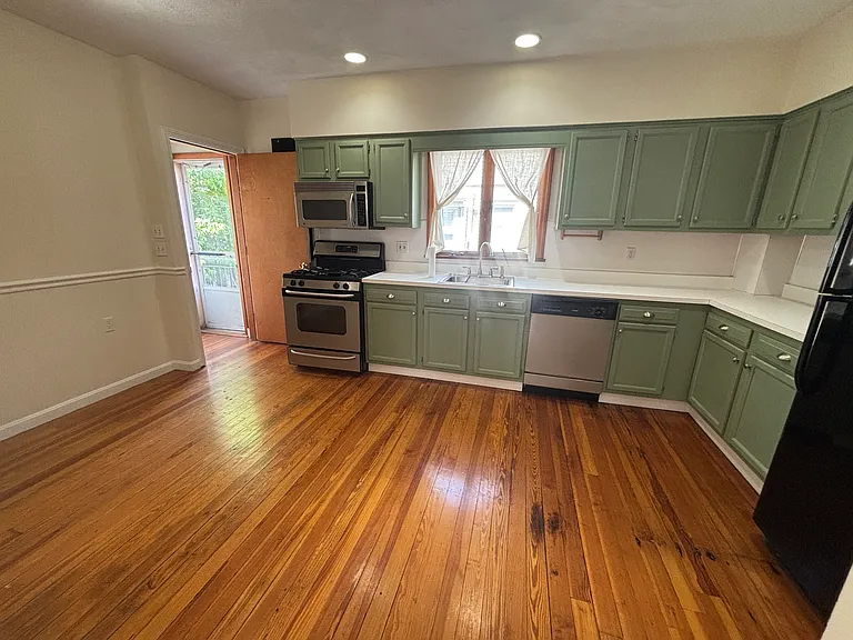 Kitchen (view to back door and hallway to basement)