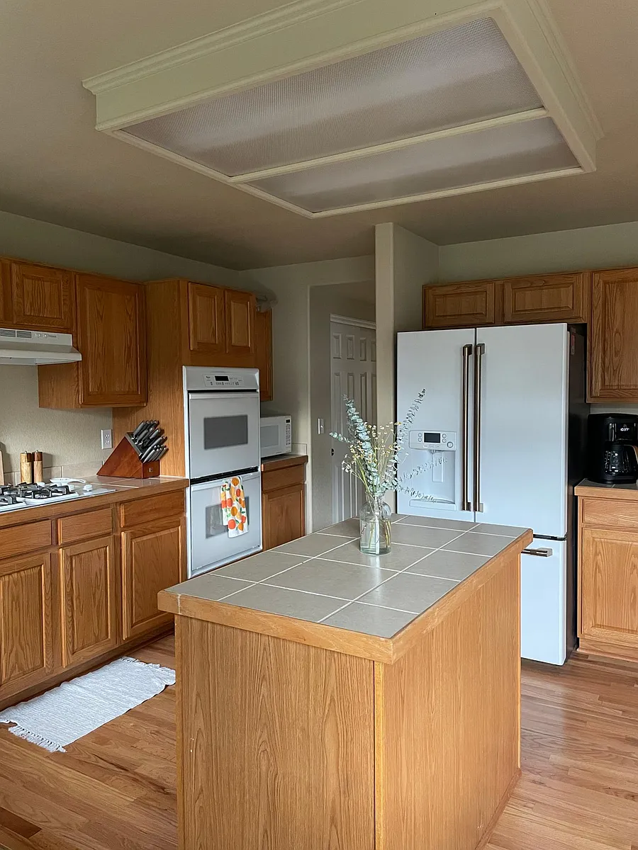Kitchen with natural gas cooktop, two stacked ovens Cafe Fridge and island - 5379 Owens St