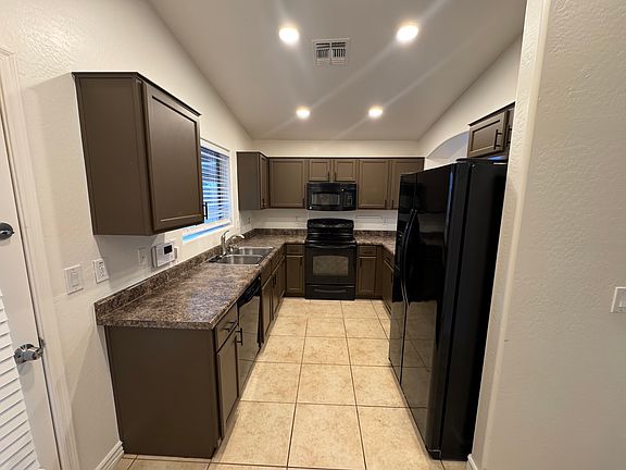 Updated kitchen with ample cabinet space, matching appliances, and breakfast bar