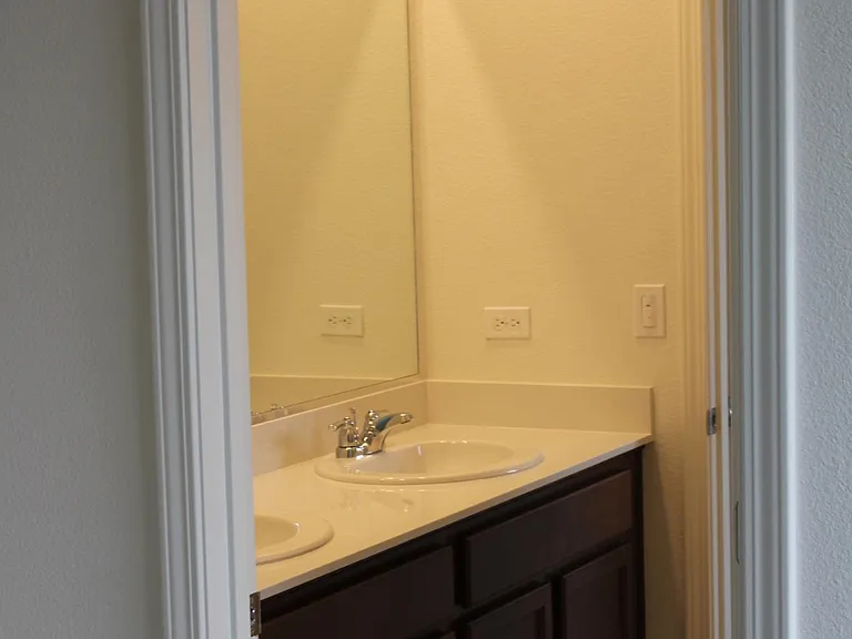 Jack and Jill bathroom accessed by both bathrooms with tub shower, toilet, dual sinks, large mirror