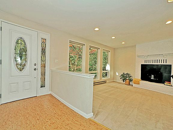 Beautiful leaded glass front door with bamboo laminate entry and living room to the right.