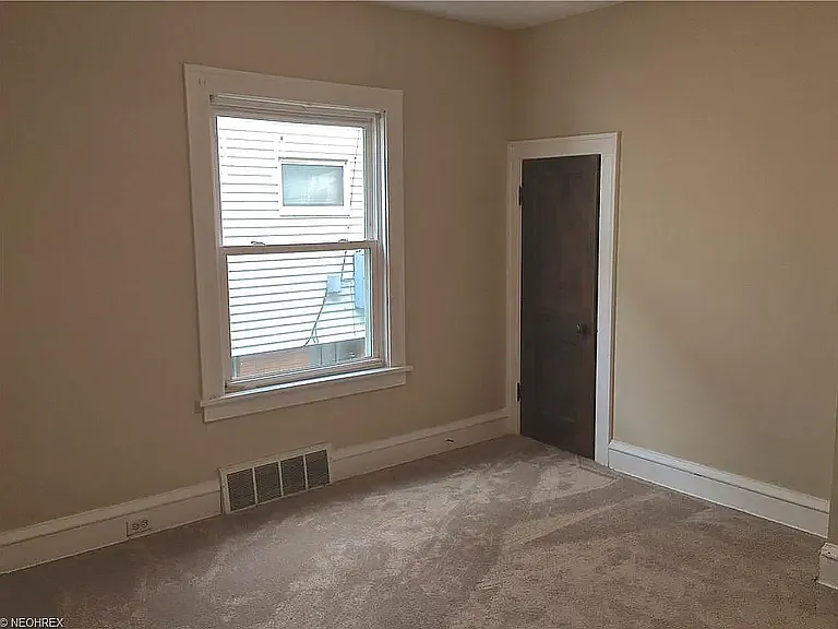 Spacious master bedroom carpeted and with a walk-in closet