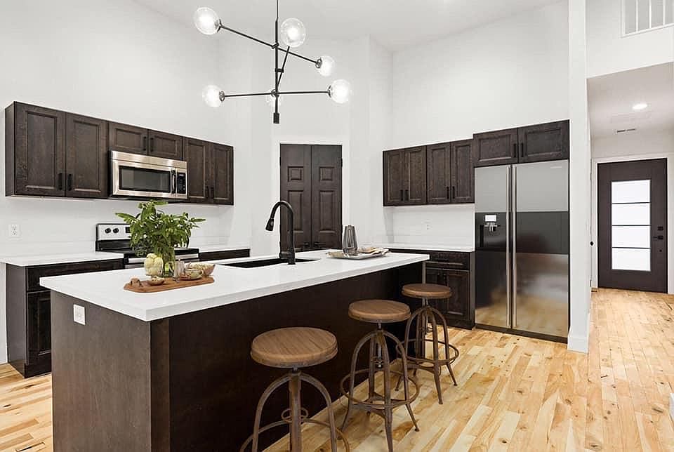 Kitchen with walk in corner pantry and Stainless steel appliances