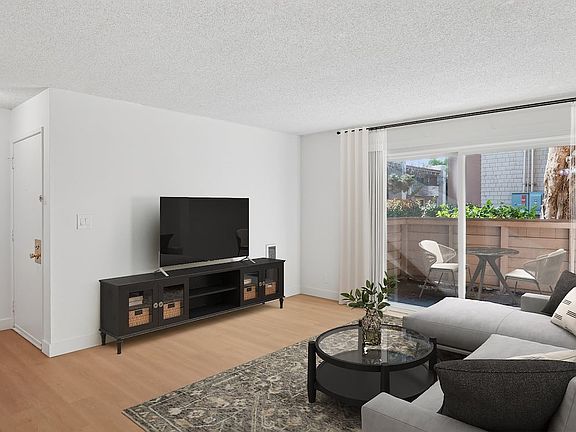 Renovated Package I living room with hard surface flooring