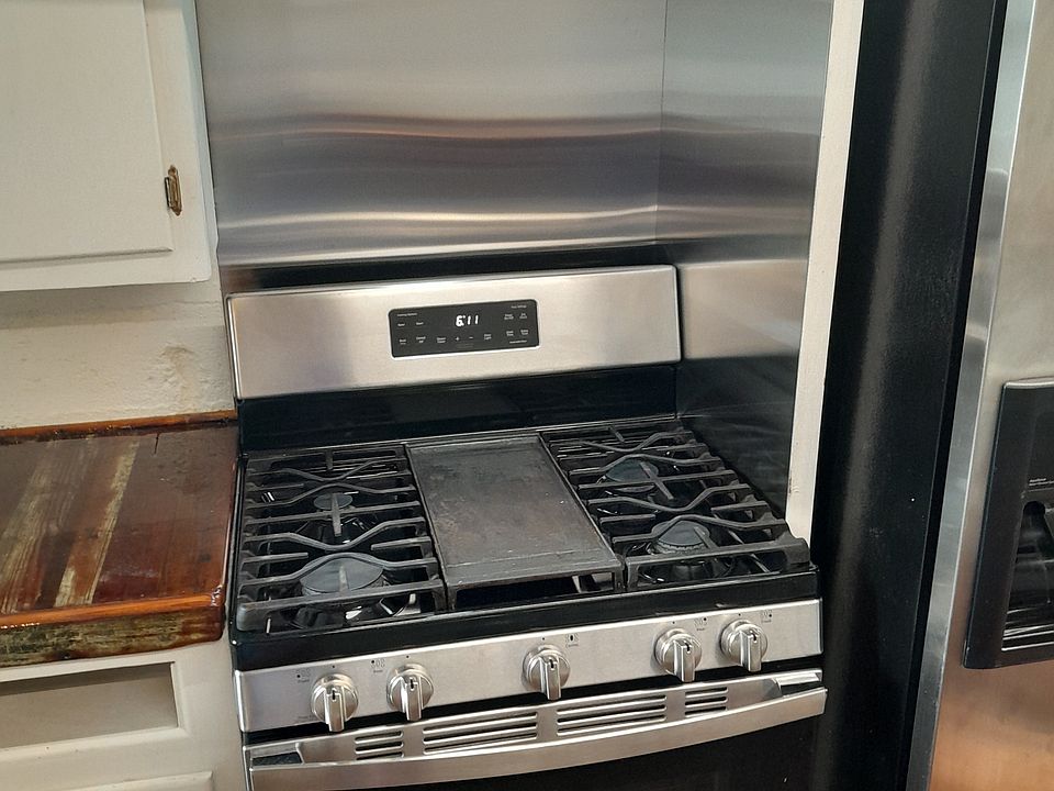 Custom Stainless Steel Backsplash and vent over gas oven with griddle