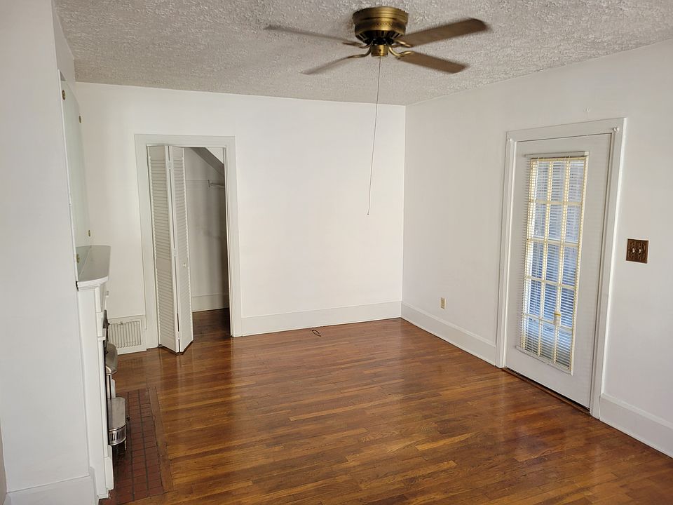 Livingroom, closet and stationary door looking out to the carpeted front porch.