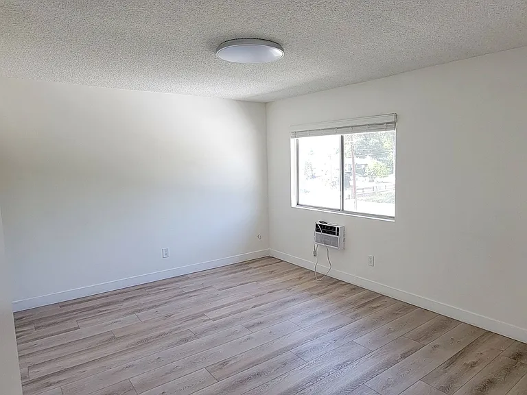 Large bedroom with lots of natural light at the Hardison Apartments in Pasadena, California.