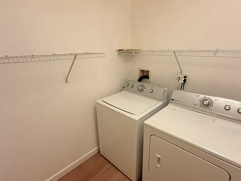 Laundry room includes washing machine and dryer, located on first floor.