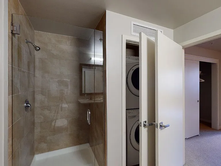Apartment bathroom with tile flooring.