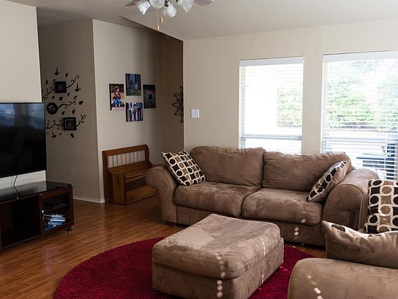 Living room - showing TV location, exit to the backyard and hallway to the 3 bedrooms