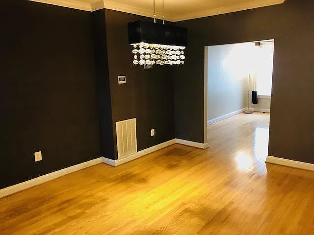 Dining room space with hardwood floors and new modern lighting