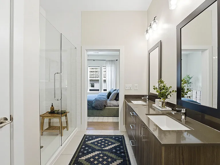 Spa bathroom with elegant glass shower with ceiling-height custom tile
