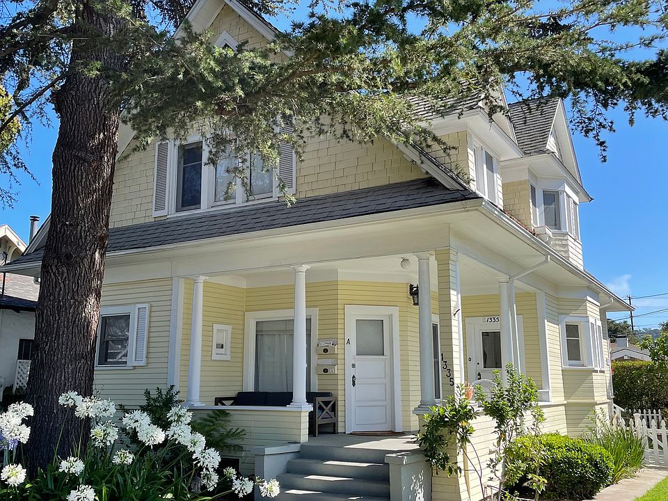 The front walkway and yard. The entrance to the upstairs flat is on the right. You enter the private foyer and ascend the classic staircase, which leads you to the spacious apartment above.