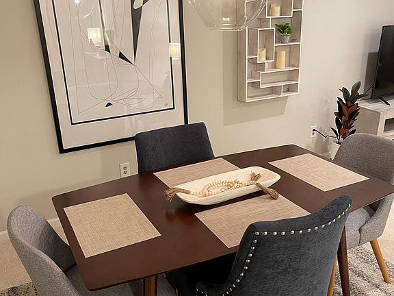 The mid-century modern dining area provides comfortable dining for four with candles and dimmable lighting for ambience in the evening.