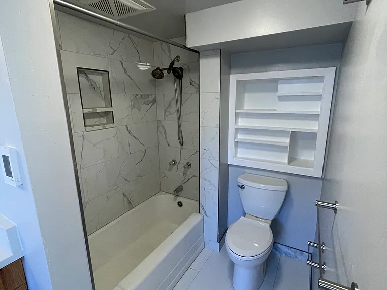 Master bath tiled shower, new fan, lights, toilet & towel racks