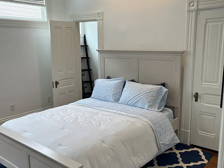 Queen bed and two walking closets on each side of the bed