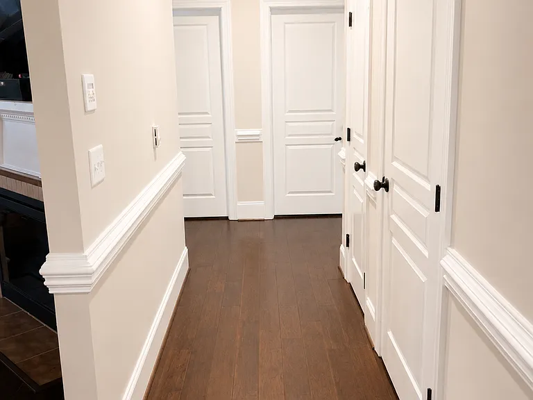 Hallway to laundry room, bathroom, and two bedroom