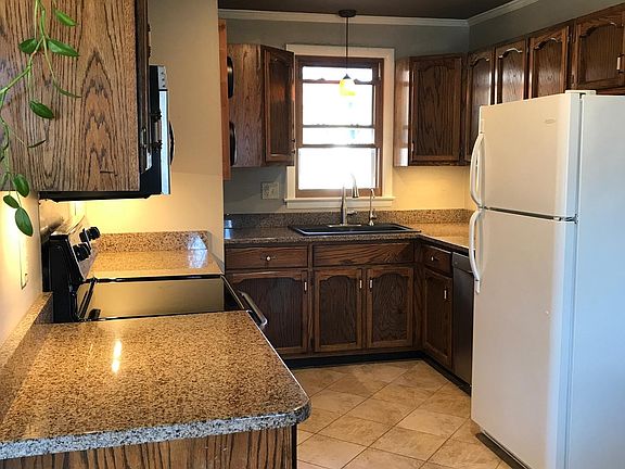 Lots of cabinets and countertop space. Dishwasher located next to the refrigerator.