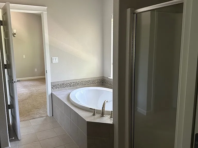 Separate shower and tub in the primary bathroom.