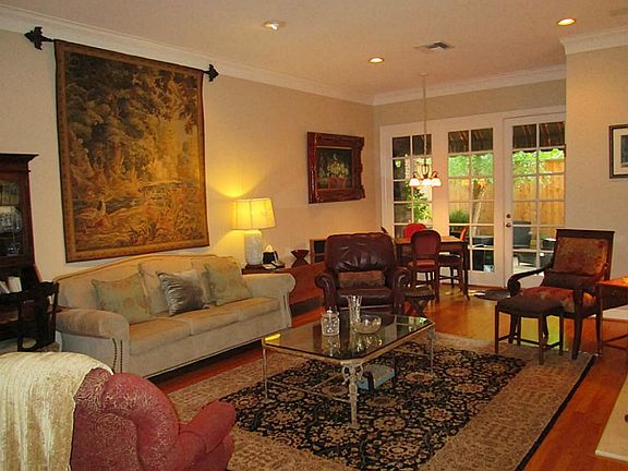 Straight ahead is the huge living room (23x16) with oak hardwood floors, French Doors to the cozy pa