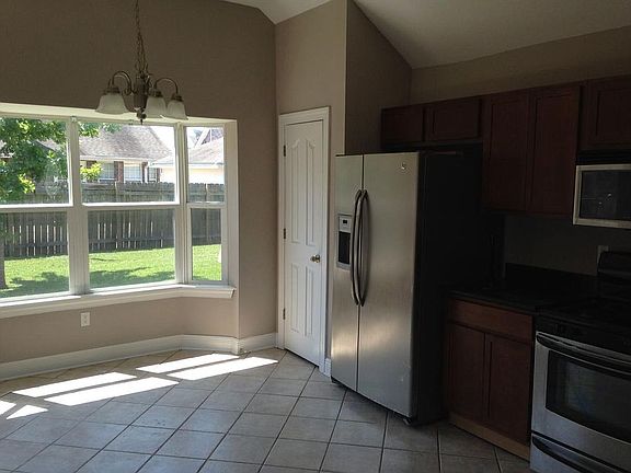 Kitchen with dining area has bay windows and lots of natural