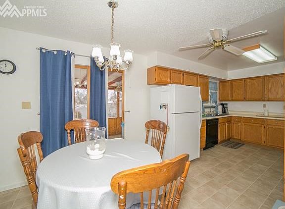 Eat-in kitchen with walk-out to enclosed patio.